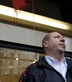 Bechtel security guard and office covered in red paint in protest